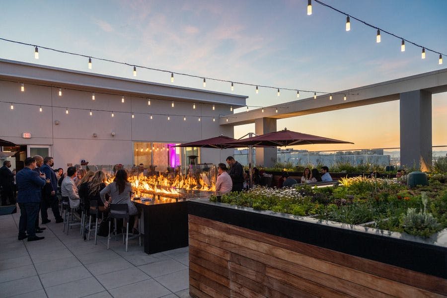 FLORA Rooftop Restaurant with string lights, perfect for evening receptions and cocktail parties.