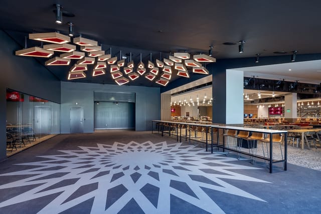 Premium Spaces in Snapdragon Stadium: modern event venue with geometric ceiling, ideal for gatherings.