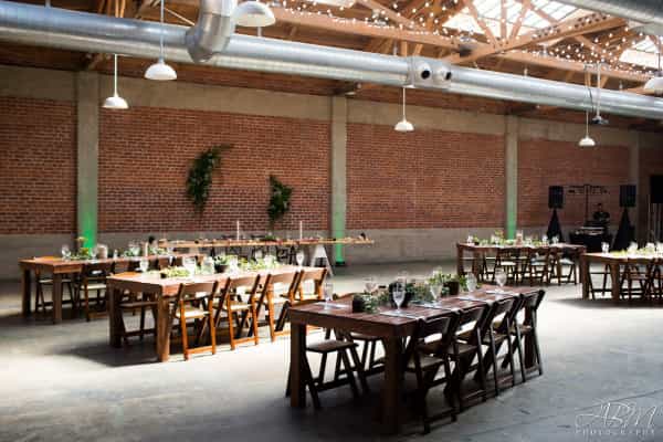 Cielo event space with rustic tables, ideal for formal dinners and casual gatherings.