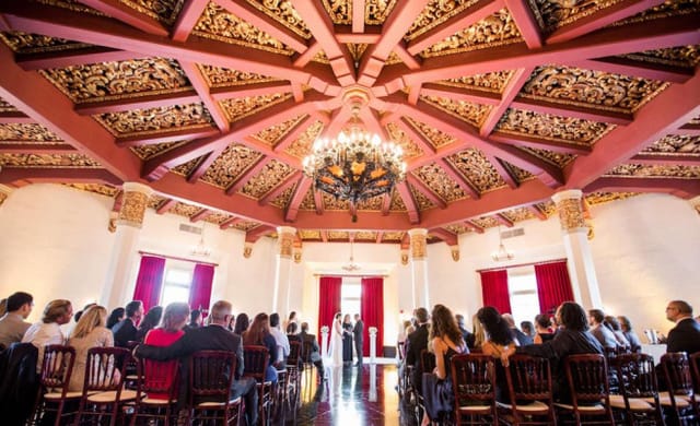 Elegant event space with ornate ceiling, ideal for weddings and formal gatherings.