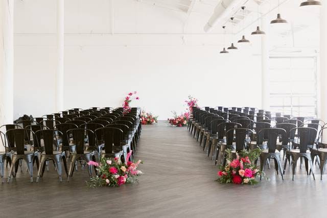 Event banquet hall at JULEP Venue with floral arrangements, ideal for ceremonies and presentations.