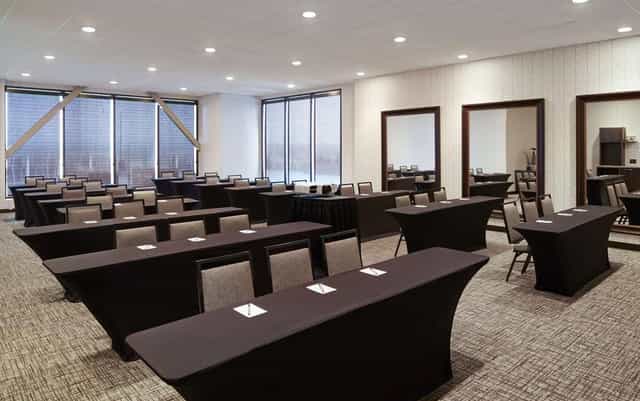 Meeting room at H Hotel LA, featuring natural light and classroom-style layout for events.
