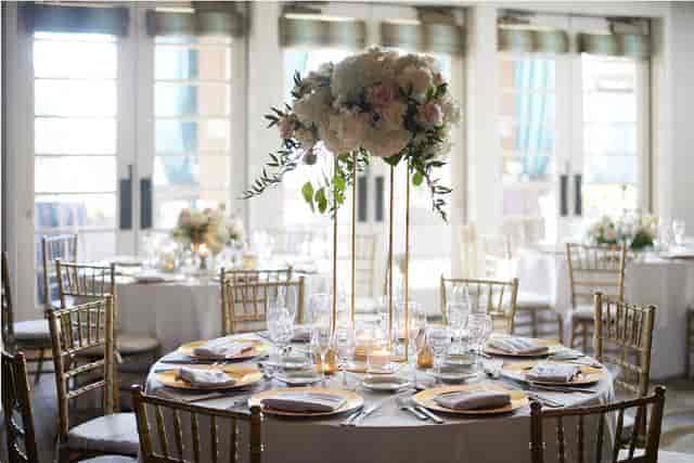 Elegant Seascape Ballroom dining setup with floral centerpiece for weddings and upscale events.
