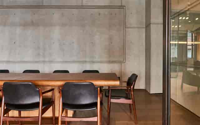 Modern conference room with wooden table and black chairs for productive meetings.