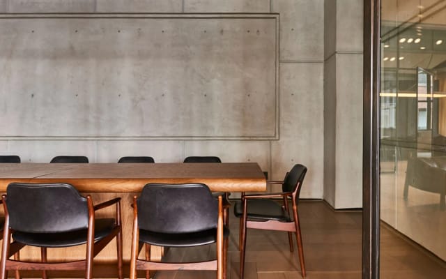Modern conference room with wooden table and black chairs for productive meetings.