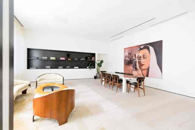 Modern minimalist library meeting space with natural light for creative collaboration events.