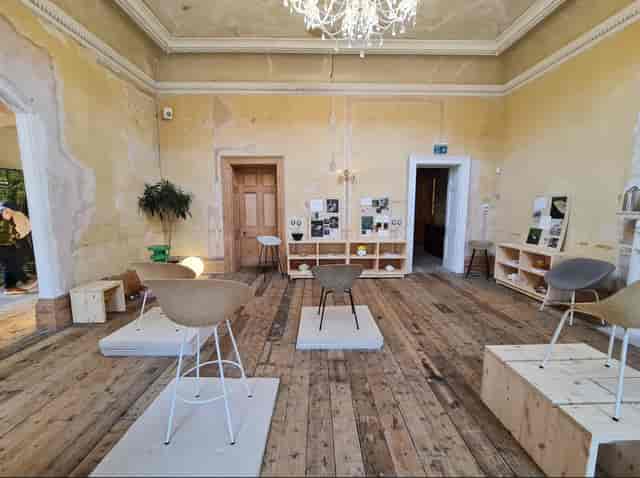 Stylish minimalist event space with wooden flooring for creative meetings and workshops.