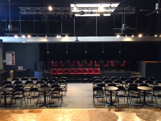 Grand Annex Music Hall concert setup with red seating for presentations and events.