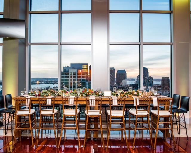 Bar area in The Ultimate Skybox with skyline view, ideal for upscale events and gatherings.