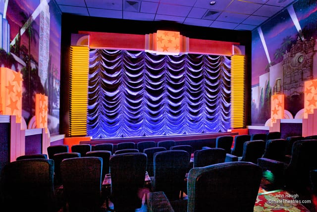 Main Screening Room at Village Theater with vibrant stage, ideal for presentations and performances.