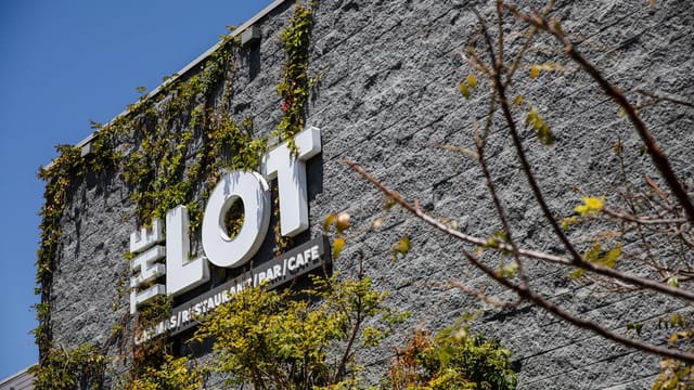 Modern restaurant exterior at The Lot, perfect for events with greenery and stylish design.