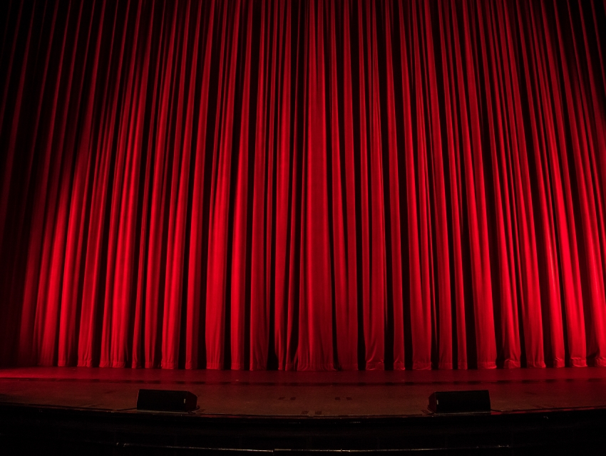 East Room in Mandeville Auditorium with rich red curtain for keynote presentation.