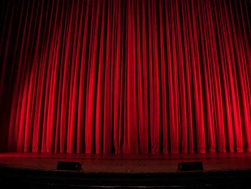 East Room in Mandeville Auditorium with rich red curtain for keynote presentation.