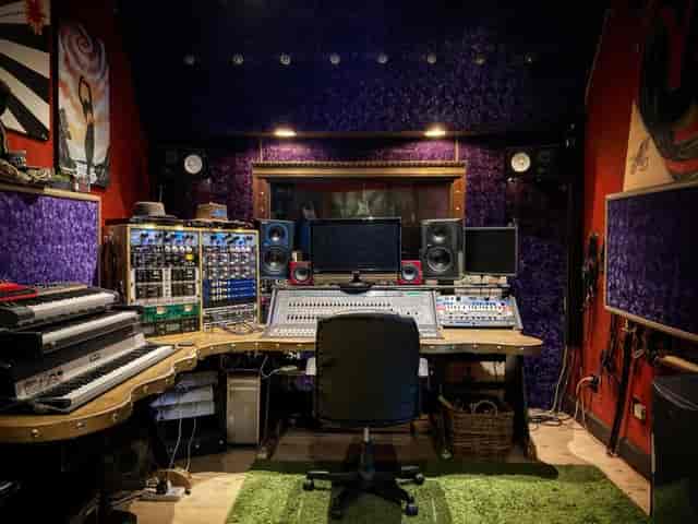 Professional recording studio with vibrant purple walls for music production events.