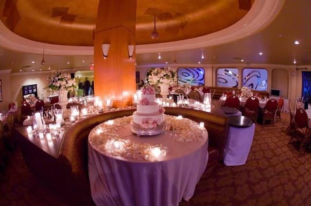 Ballroom at Kona Kai Resort, elegant wedding reception with floral decor and cake.