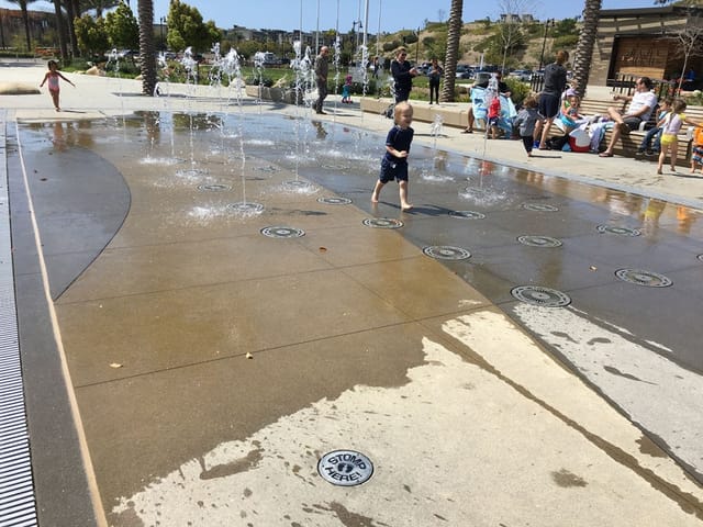 Splash pad at Civita Park, vibrant water features for family-friendly summer events.
