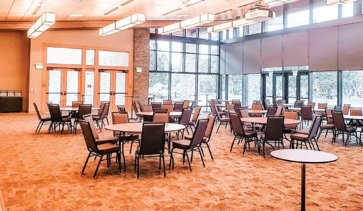 Dance Room at Mountain View Community Center with round tables for networking events.