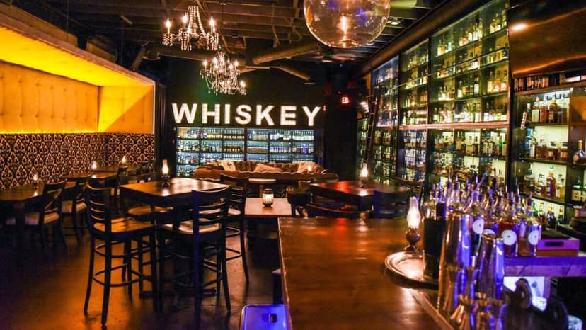 Stylish Whiskey Club bar with warm lighting, perfect for intimate gatherings and networking events.