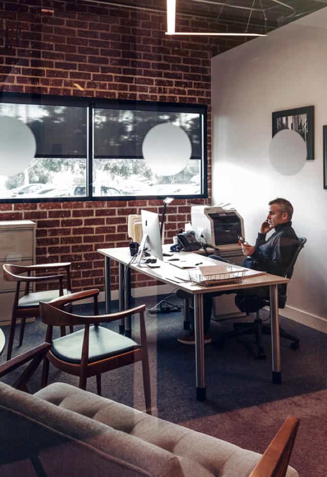 Team Pods in BizHaus: modern office with minimalist desk, ideal for event planning.