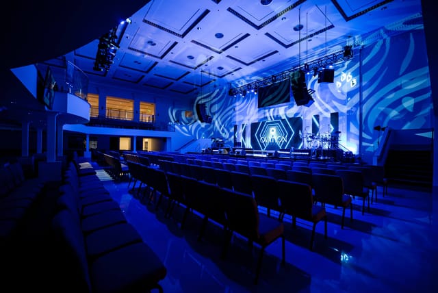 Modern event space in Ovation Square with dynamic lighting for conferences and concerts.