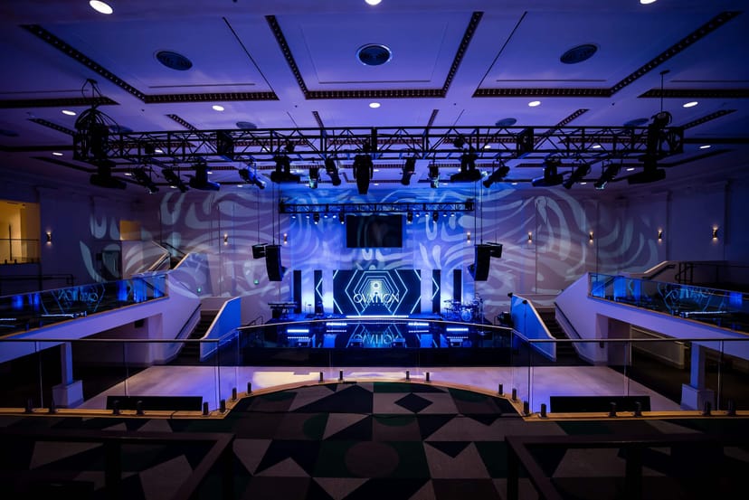 Modern event space in Ovation Square with tiered seating for conferences and performances.