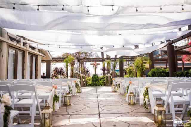 Outdoor wedding venue with elegant aisle and floral accents at Ranch Events.