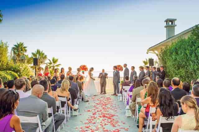 Outdoor wedding ceremony at Lagunita Pavilion with rose petal aisle and floral decor.