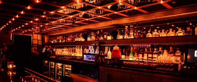 Stylish bar in F6ix with warm lighting, perfect for cocktail receptions and networking events.
