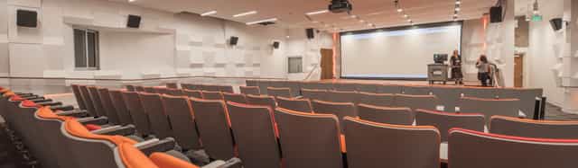 Modern auditorium with tiered seating for conferences and seminars.