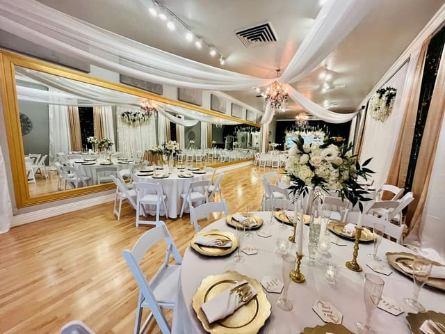 Elegant dance studio with gold-accented tables, perfect for weddings and upscale events.