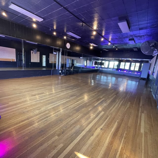 Spacious dance studio with polished floors, ideal for classes and events.
