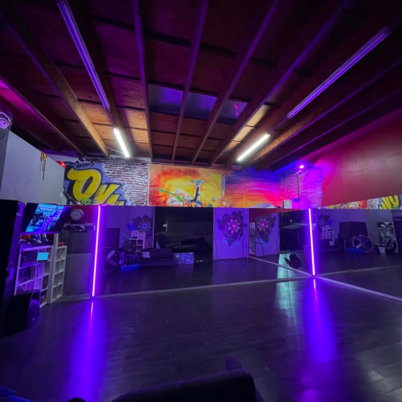 Vibrant dance studio with graffiti art, ideal for classes and creative events.