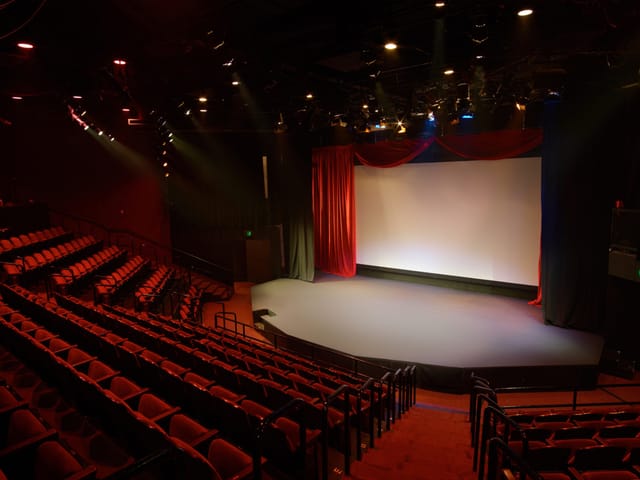 Thrust Stage at The Colony Theatre, ideal for performances and conferences with professional lighting.