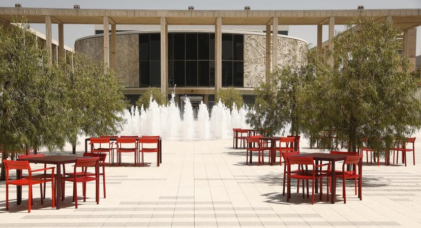 Mark Taper Forum outdoor event space with red tables, ideal for networking gatherings.