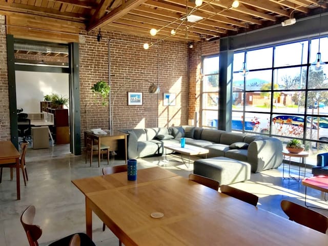 Modern Iona meeting room with exposed brick walls, ideal for collaborative events.