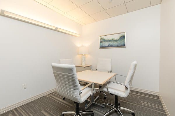 Private office meeting room with minimalist decor for team meetings and client consultations.