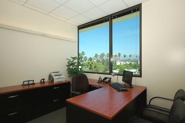 Bright private office with large windows, ideal for meetings in Premier Workspaces.