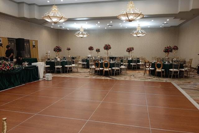 Elegant Smaller Hall setup with green tablecloths for weddings and formal events.