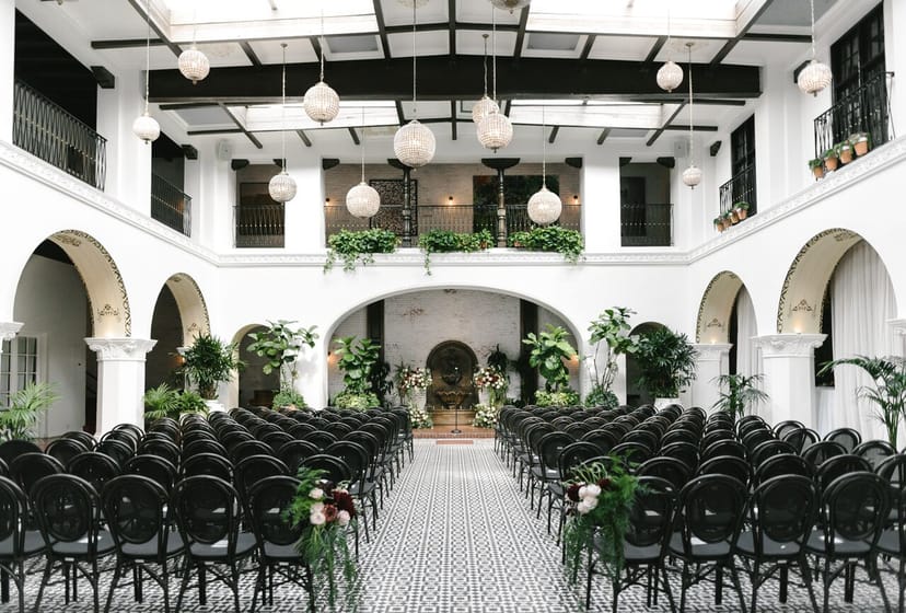 Elegant banquet hall with black chairs, perfect for weddings and formal events.