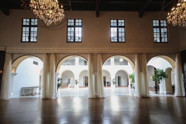 Elegant banquet hall with arched openings, ideal for events and gatherings.