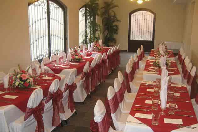 Elegant event space at Epoca Hall with red tablecloths, perfect for weddings and celebrations.