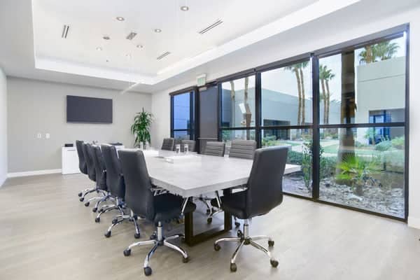 Modern conference room with large table, ideal for corporate meetings and brainstorming sessions.