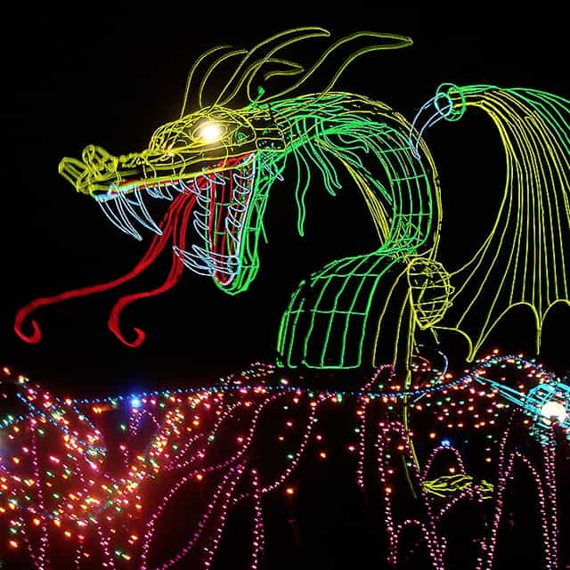 Vibrant illuminated dragon float for themed events and festivals.