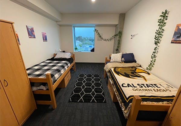 Cal State LA dorm meeting room with twin beds, ideal for retreats and workshops.