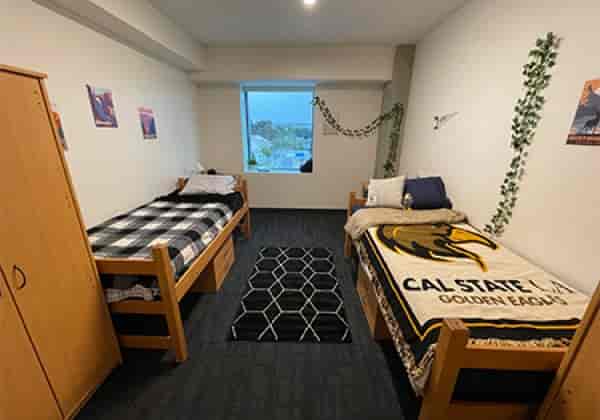 Cal State LA dorm meeting room with twin beds, ideal for retreats and workshops.