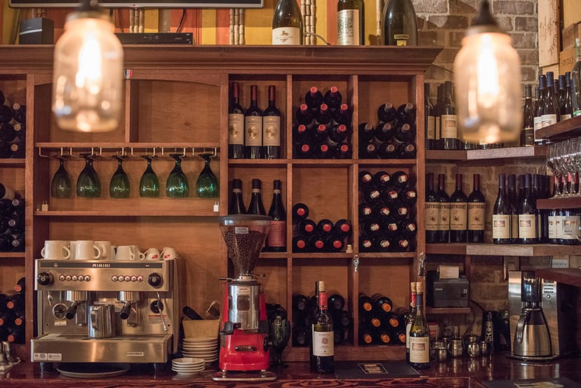 Bar area with wine bottles and glassware, ideal for networking events and gatherings.