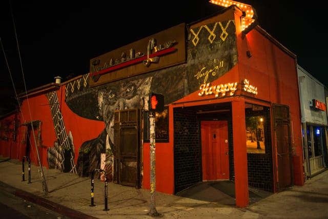 Vibrant Eastside Luv Wine Bar with bold mural, perfect for social events and parties.