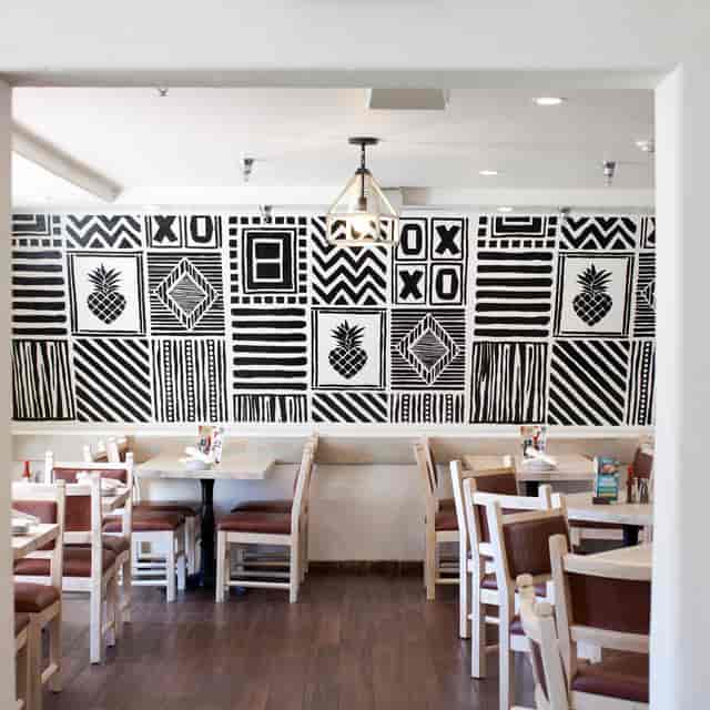 Main Dining Area in Acapulco Downey with black-and-white wall, ideal for events and meetings.