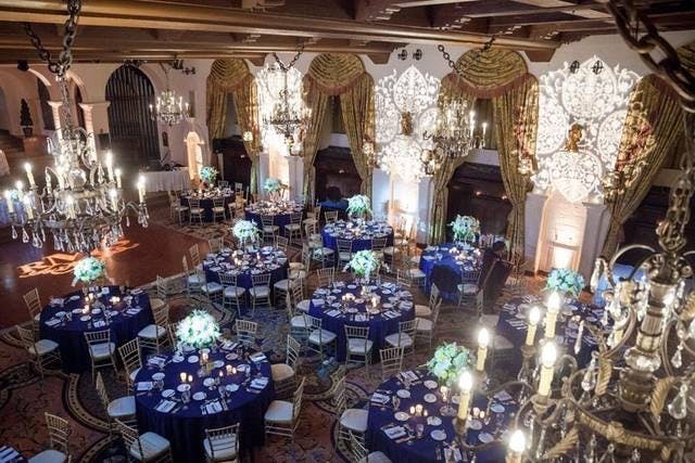 Elegant Grand Parisian Ballroom with blue linens, ideal for weddings and upscale events.