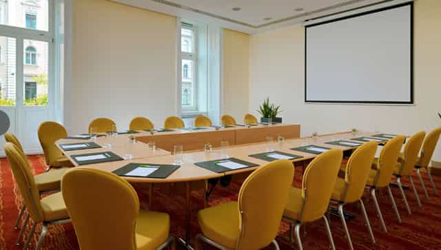 Meeting room with large table and yellow chairs at Courtyard by Marriott.
